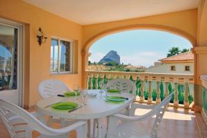 a dining room with a table and chairs on a balcony at Villa Senieta - PlusHolidays in Calpe