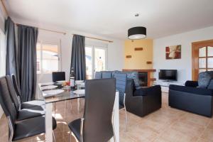 a living room with a table and chairs and a couch at Villa Senieta - PlusHolidays in Calpe