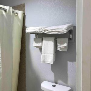 a bathroom with towels hanging on a wall at Walnut Inn - Checotah in Checotah