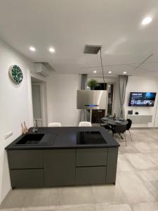 a kitchen with a black counter top in a living room at The Jungle Home in Naples