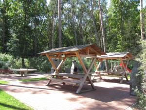 a picnic table with a pavilion in a park at Ostseepark Zempin in Zempin