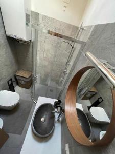 a bathroom with a sink and a shower at Mansarda Eghel in Lavarone