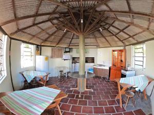 a kitchen with a table and chairs in a room at Pousada Verde Agua in São Lourenço do Sul