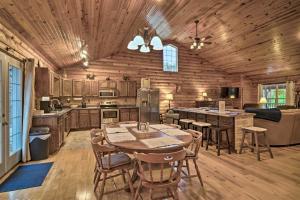 a kitchen with a table and chairs in a cabin at Woodsy Kentucky Escape with Game Room and Lake Access! in Burnside