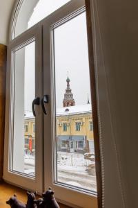 a window with a view of a building at Апарт-отель Мечтатели Бесконтактное Заселение in Yaroslavl