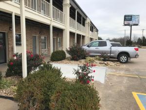 a truck parked in a parking lot in front of a building at Walnut Inn - Checotah in Checotah