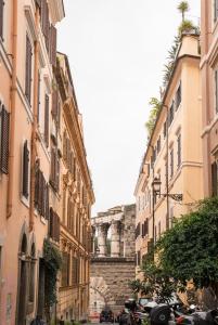 a group of buildings in a street with parked cars at Colosseum Townhouse in Rome