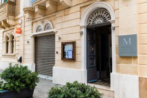 a entrance to a building with a black door at Monreal Boutique Townhouse - R024RM3 in Paola