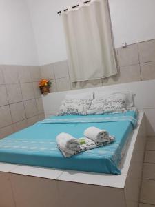 a bed with towels and pillows on top of it at Hotel Paradiso in João Pessoa +37 photos