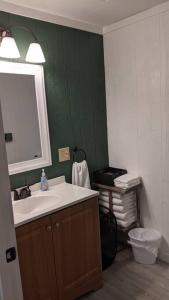 a bathroom with a sink and a mirror at Cabin 3 - Modern Cabin Rentals in Southwest Mississippi at Firefly Lane in Summit