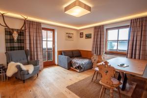 a living room with a couch and a table at Appartements Kirchenwirt in Kirchberg in Tirol