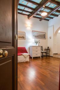 a bedroom with a bed and a dresser in a room at Colosseum Townhouse in Rome