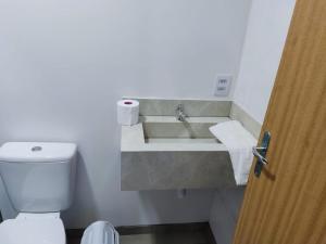 a bathroom with a sink and a toilet at Pousada Vila dos Sonhos in Ituporanga
