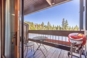 a balcony with a table and chairs on a deck at Hotel Style Room in The Timber Creek Lodge condo in Truckee