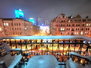 a view of a city at night from a balcony at Яркая история in Kyiv