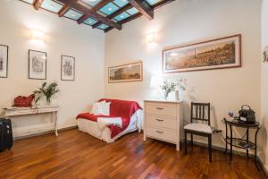 a bedroom with a bed and a dresser at Colosseum Townhouse in Rome
