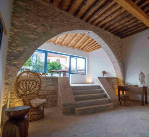 a room with an archway with a chair and stairs at The Courtyard Episkopi Guest Houses in Episkopi Limassol