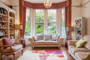 a living room with two couches and a large window at LUXURY HOME - CENTRAL WINDSOR, GATED PARKING in Windsor