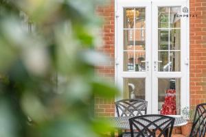 a table and chairs in front of a window at LUXURY HOME - CENTRAL WINDSOR, GATED PARKING in Windsor