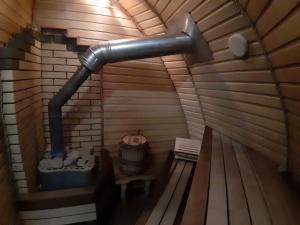 an inside view of a sauna with a pipe at Cave Sorceress Gingemma in Petrovo