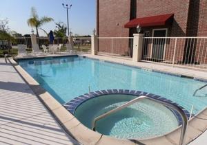 a large swimming pool in front of a building at Hawthorn Extended Stay by Wyndham Port Arthur in Port Arthur