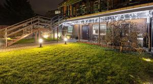 a lawn in front of a building at night at Apartament w Centrum Ostróda in Ostróda