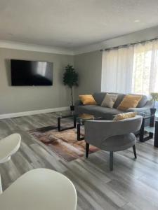 a living room with a couch and a tv at ENTIRE 2 BEDROOM APARTMENT DOWNTOWN - u3 in Waterloo
