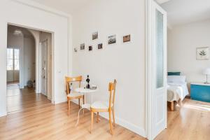 a white room with a table and chairs and a bed at AriediParma Appartamenti in Parma +32 photos