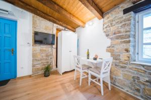 a room with a table and chairs in a brick wall at Apartments Villa San Vito in Grožnjan