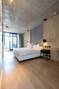 a large bedroom with a white bed and a large window at Krista Boutique Hotel in Buenos Aires