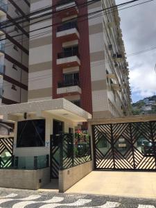 a building with a balcony in front of it at Pé na areia em Santos in Santos