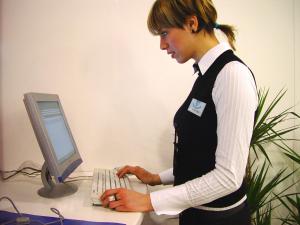 a woman is typing on a computer keyboard at Hotel Diamond NUOVA GESTIONE in Riccione +128 photos