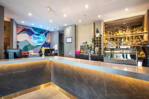 a bar with a large counter in a restaurant at Royal Hotel by Nightcap Social in Melbourne