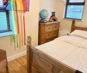 a bedroom with a bed with a rainbow flag on the wall at The Historic Wee Green House in Carrigart