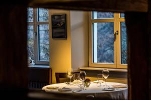 a table in a restaurant with wine glasses on it at Waldhotel Fletschhorn Saas-Fee in Saas-Fee