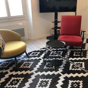 a living room with two chairs and a rug at Duplex familial # Pein centre # BESTOFBLO #INSEAD in Fontainebleau