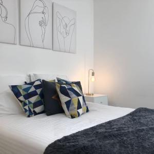 a bedroom with a bed with pillows and drawings on the wall at Duplex familial # Pein centre # BESTOFBLO #INSEAD in Fontainebleau