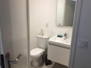a white bathroom with a toilet and a sink at Duplex familial # Pein centre # BESTOFBLO #INSEAD in Fontainebleau +13 photos