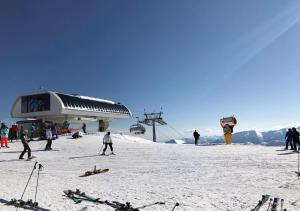 a group of people on a ski slope with a ski lift at Rustic House BINA 5 in Gudauri