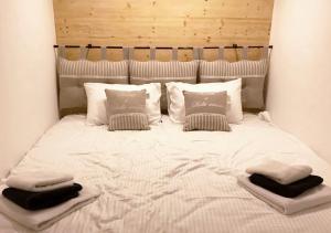 a large white bed with pillows on top of it at Rustic House BINA 5 in Gudauri +39 photos