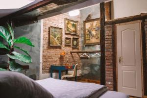 a room with a brick wall with a blue table at The House a la Cluj in Cluj-Napoca