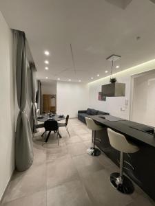 a living room with a couch and a table and chairs at The Jungle Home in Naples +18 photos