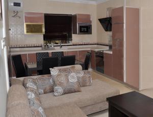 sala de estar con sofá y cocina en منازل بجيلة للاجنحة الفندقية Manazel Begela Hotel Apartments, en Taif