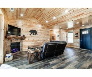 a living room with a couch and a fireplace at Sky Ridge Mountain View Wheelchair Accessible and Swim Spa in Gatlinburg