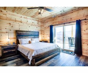 a bedroom with a bed and a large window at Sky Ridge Mountain View Wheelchair Accessible and Swim Spa in Gatlinburg +71 photos