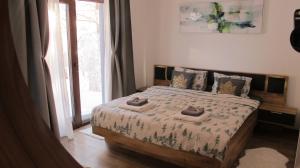 ein Schlafzimmer mit einem Bett mit zwei Handtüchern darauf in der Unterkunft Apartman Pinewood Divcibare in Divčibare