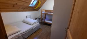 a small bedroom with a bed with a banana on the ceiling at Maison familiale au centre de Loudenvielle in Loudenvielle