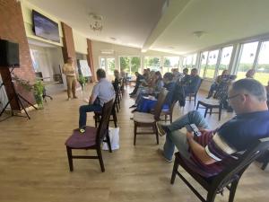 a group of people sitting in chairs in a room at More Guesthouse in More