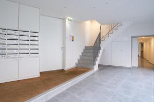 a hallway with a staircase and a stair case at Habitatio - Foz by LuxiStay in Porto