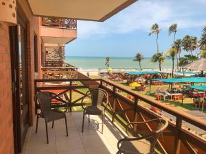 a balcony with chairs and a view of the beach at Kariri Beach - 207 - Praia do Cumbuco, Caucaia in Cumbuco
